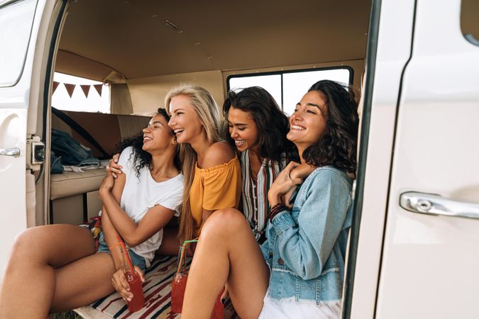 Smiling and laughing women in the back of a van