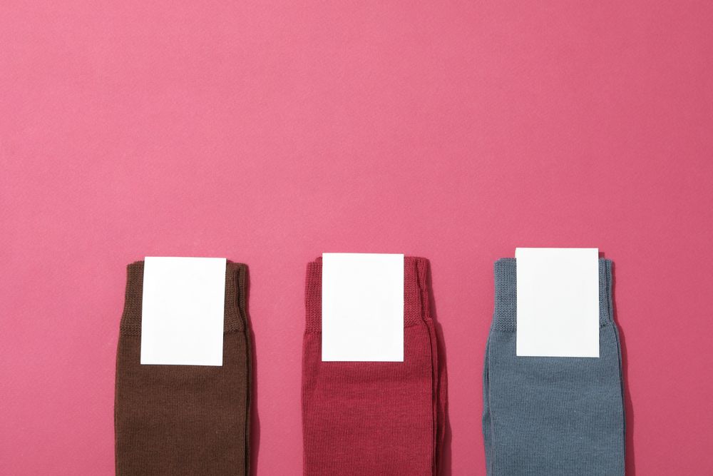 Multicolored high socks on a pink background.