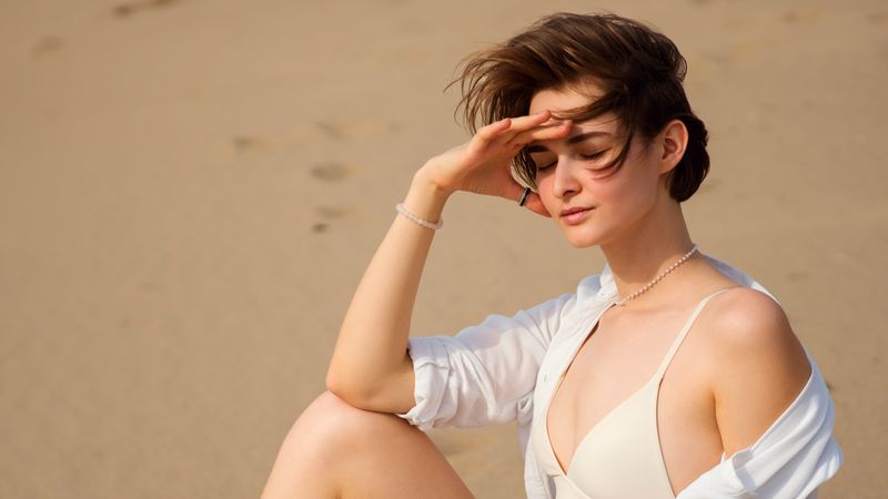 Woman relaxing on beach sand