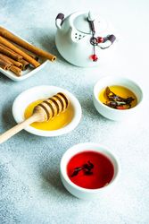 Tea on stone background with cinnamon and honey