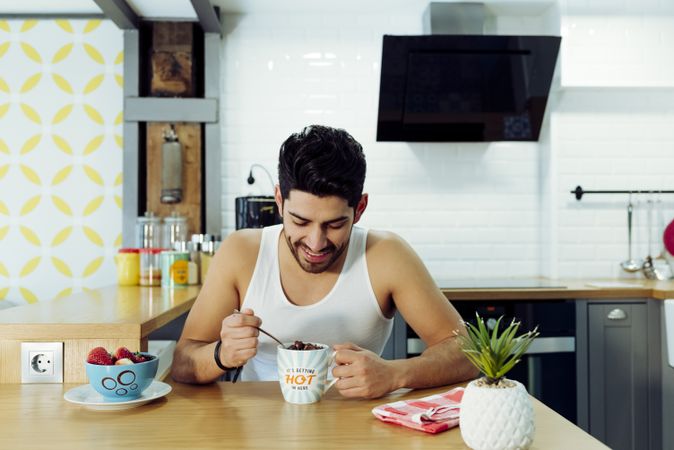 Happy man holding cup of coffee with chocolate