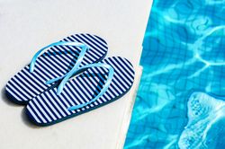 Stripped flip-flops on edge of pool