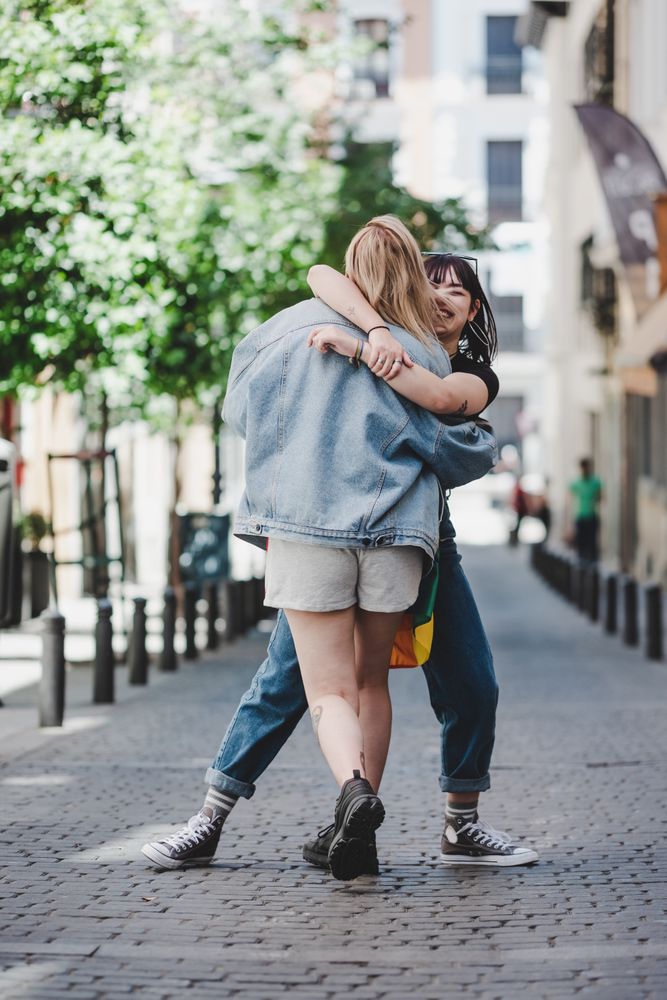 Happy lesbian couple having fun on street