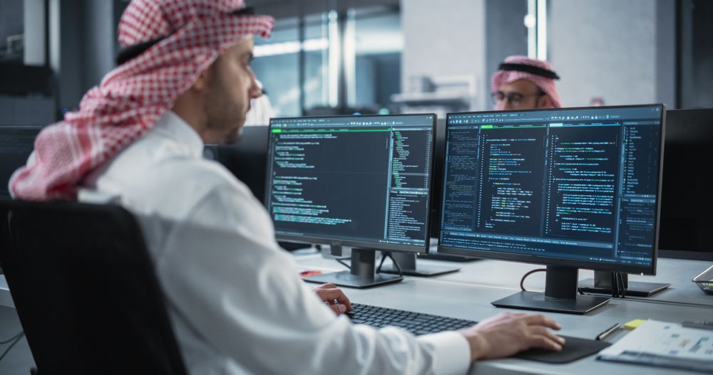 Arab Telecommunications Manager Working in a Research and Development Facility on a Desktop Computer.