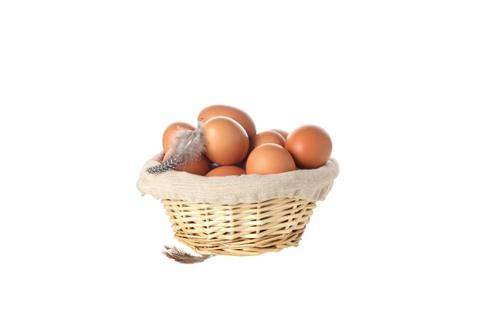 eggs in a round basket, isolated on blank background.