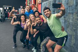 Athletes taking a selfie with the mobile in the gym