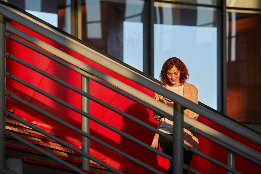 young female communicating via smartphone at station