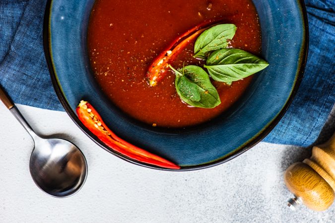 Top view traditional Spanish soup of tomato gazpacho in blue bowl