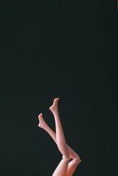 Doll legs on dark background