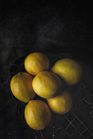 Fresh lemons on dark background.