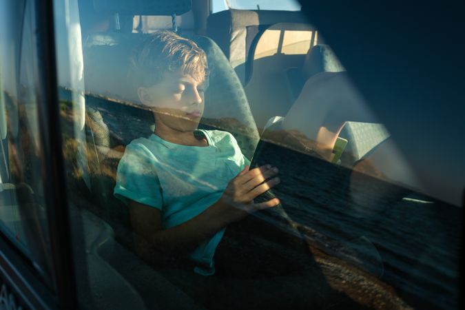Travelling boy resting in car