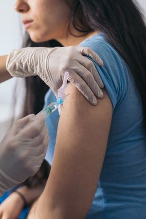 nurse giving a vaccine to a patient. Close-up