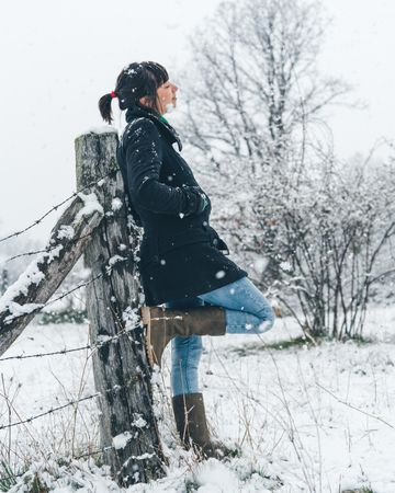 Young woman enjoying snow day on countryside