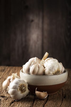Garlic bulb and garlic cloves on the wooden table.