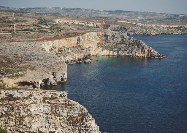 Rocky cliffs surrounding the Mediterranean Sea of Malta