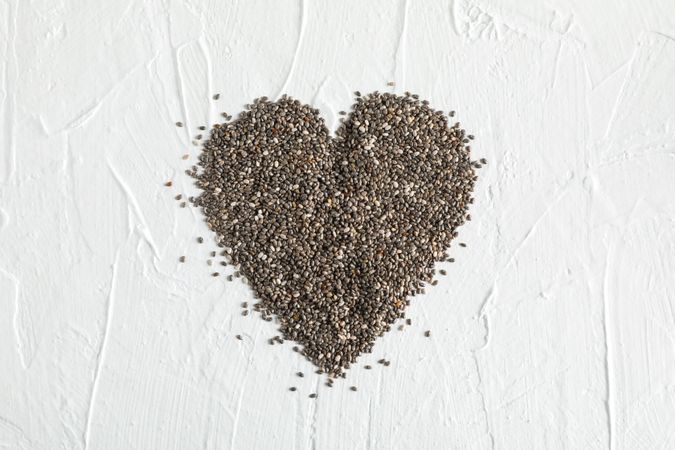 Heart layout of chia on neutral background, copy space