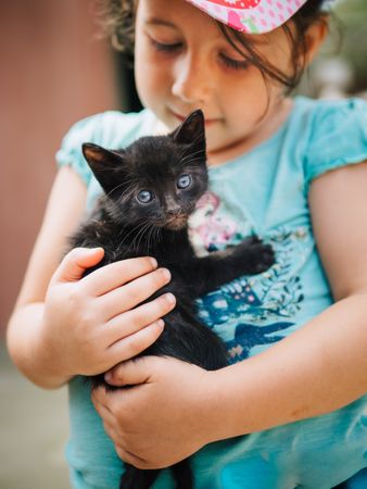 cute little girl holding a pussycat