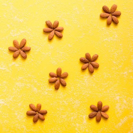 Almond in flower pattern on yellow background