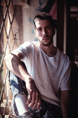 Man in abandoned building near bars