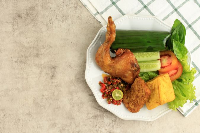 Top view of Indonesian chicken with tempeh and vegetables