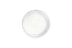 Cosmetic cream in glass jar isolated on plain background