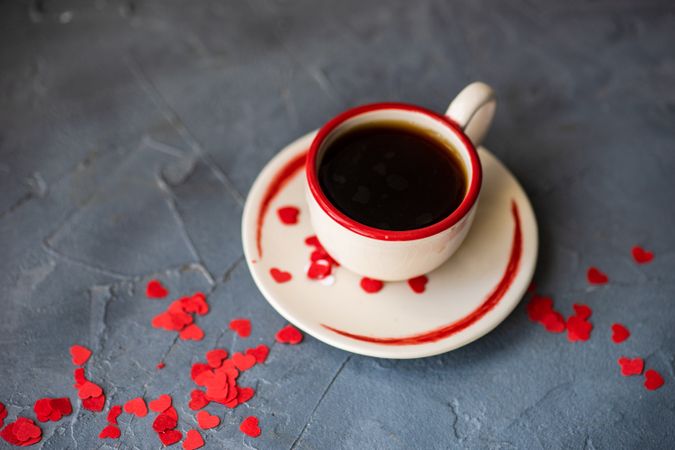St. Valentine day card concept of coffee with red heart confetti
