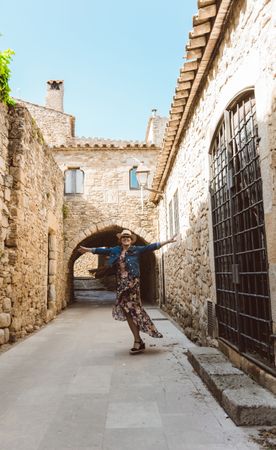 Woman walking in a narrow path in a village