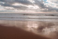Waves coming in on quiet beach in the morning