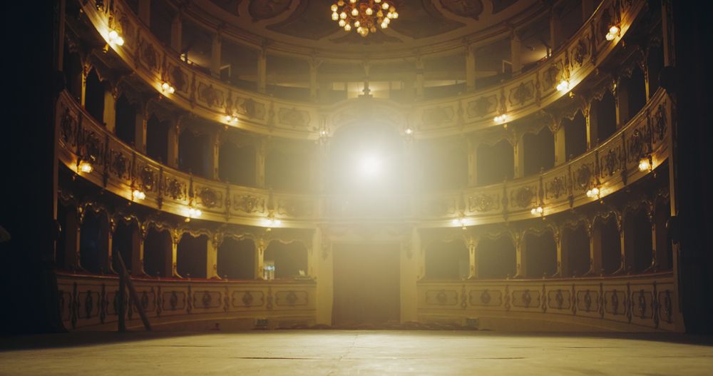 Wide shot of an Empty Elegant Classic Theatre with Spotlight Shot from the Stage.