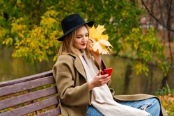 Woman on park bench in autumn