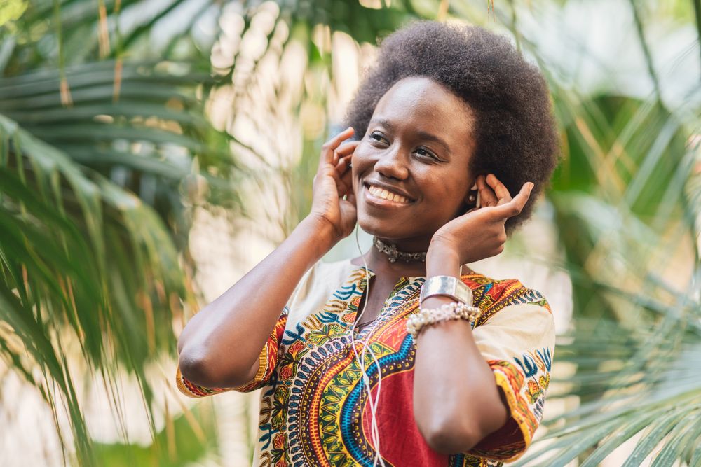 Smiling Black woman listening to music