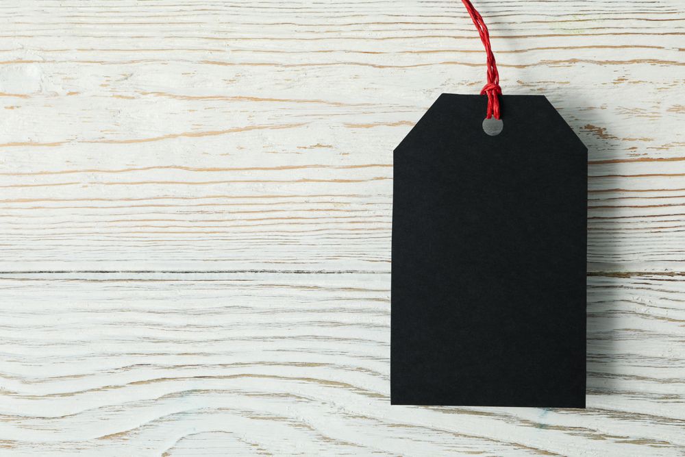 Blank dark tag on wooden background