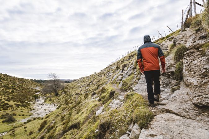 Man walking on hill near valley