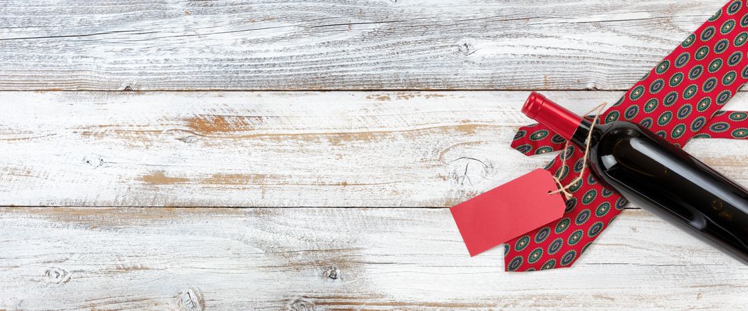 Dotted tie and red wine gift on rustic wood for Father’s Day background