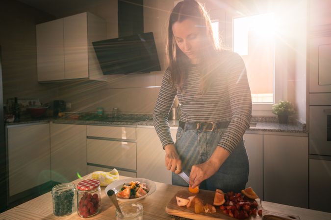 Woman cutting fruits in kitchen