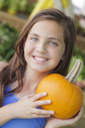 Girl Having Fun with the Pumpkins at Market