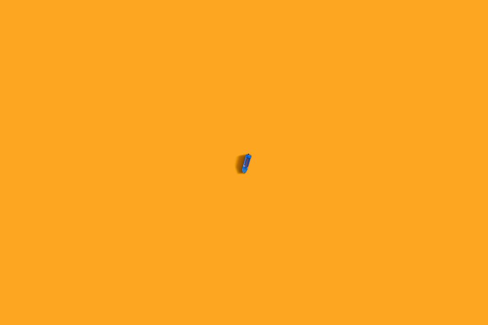 One single boat floating in orange waters