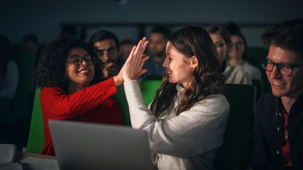 Young Female and Male High Five to Celebrate a Successful Result