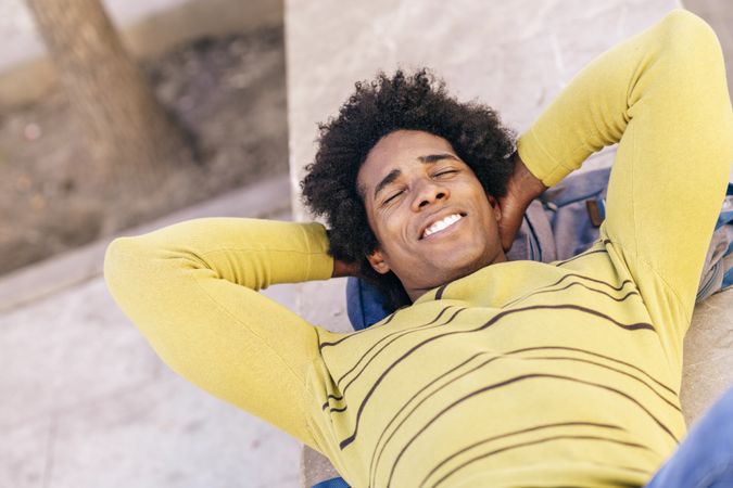Man laying back and relaxing outside