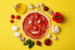 Ingredients for cooking pizza on yellow background, top view