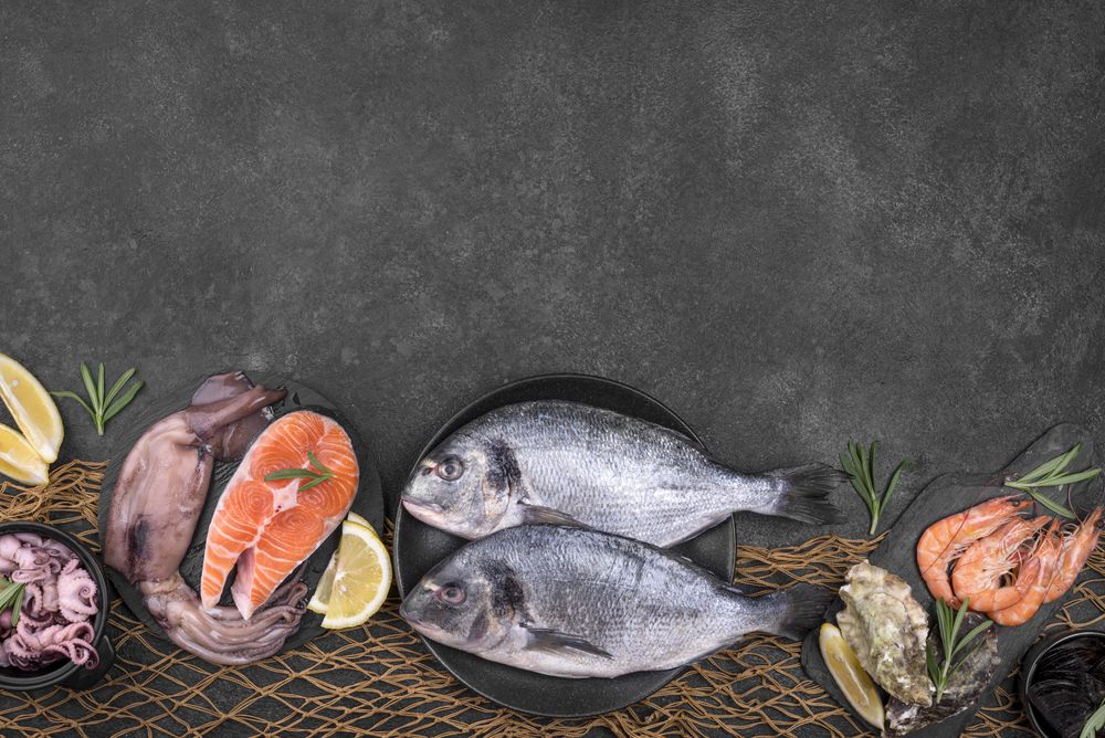 Arrangement of various types fish with copy space