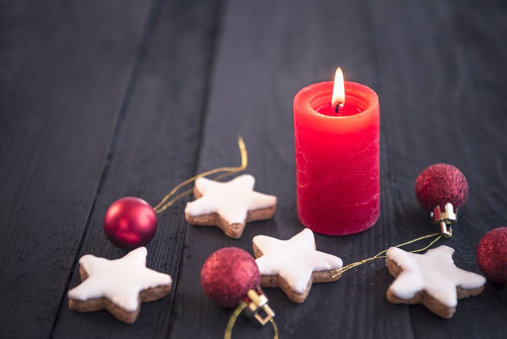 Red candle on wooden table and Xmas elements