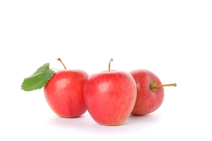Sweet red apples isolated on light background