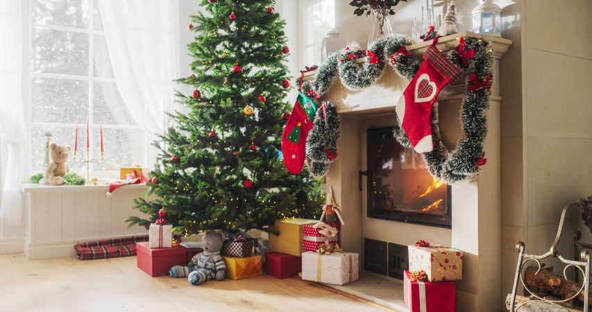 Decorated Corner in Modern House with Christmas Tree, Fireplace and Gifts. Home of a Family Celebrating with Joy
