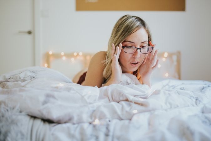 Woman lying in bed at home