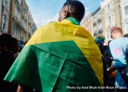 Back of Black man draped in Jamaican flag 43kMR4