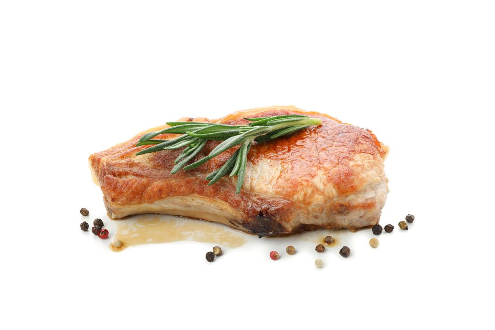 Fried pork steak isolated on light background. Grilled food