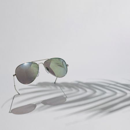 Aviator sunglasses with palm tree shadow