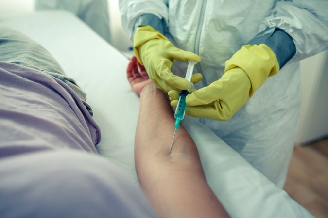 Doctor injecting a vaccine to a patient