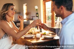 Romantic couple sitting at dining table at home 42KJmb